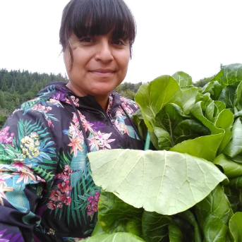 Letty in garden next to vegetables